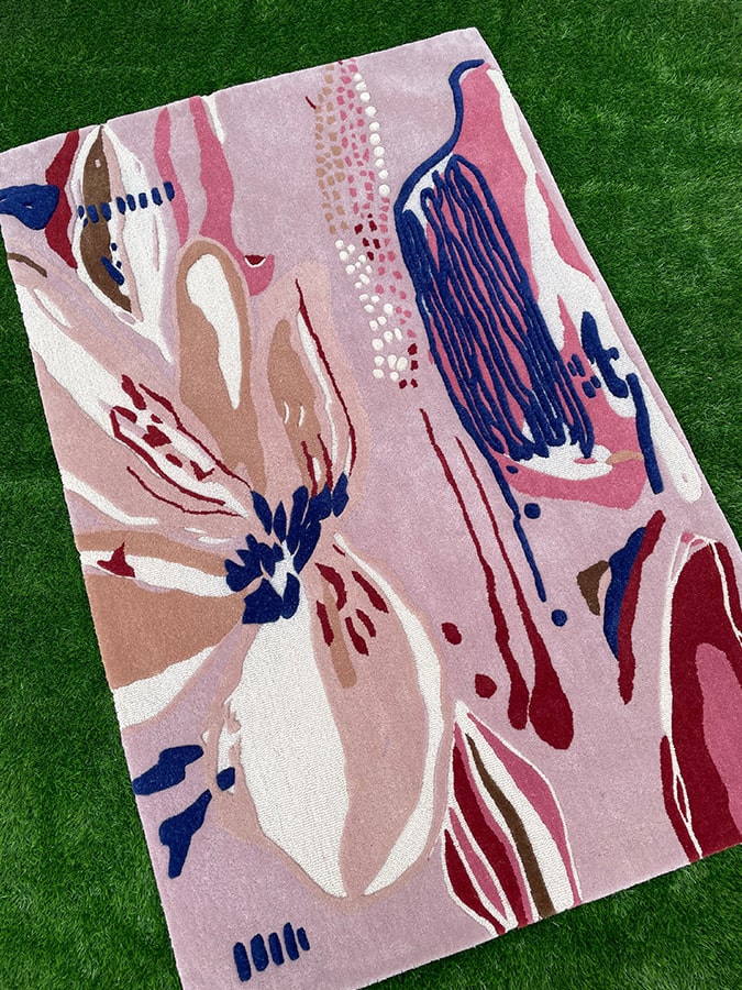 Bloom Rug showcasing its vibrant multi-colored design and soft texture, hand-tufted from fine New Zealand wool.