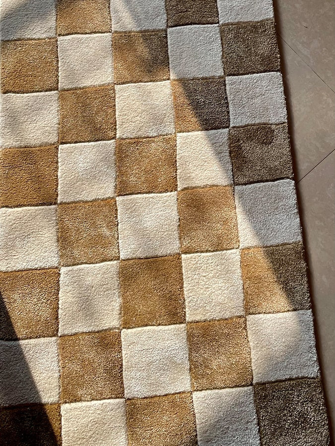 Close-up of the Checkmate Rug's soft texture and intricate embossing, highlighting the craftsmanship and strategic design inspired by chess.
