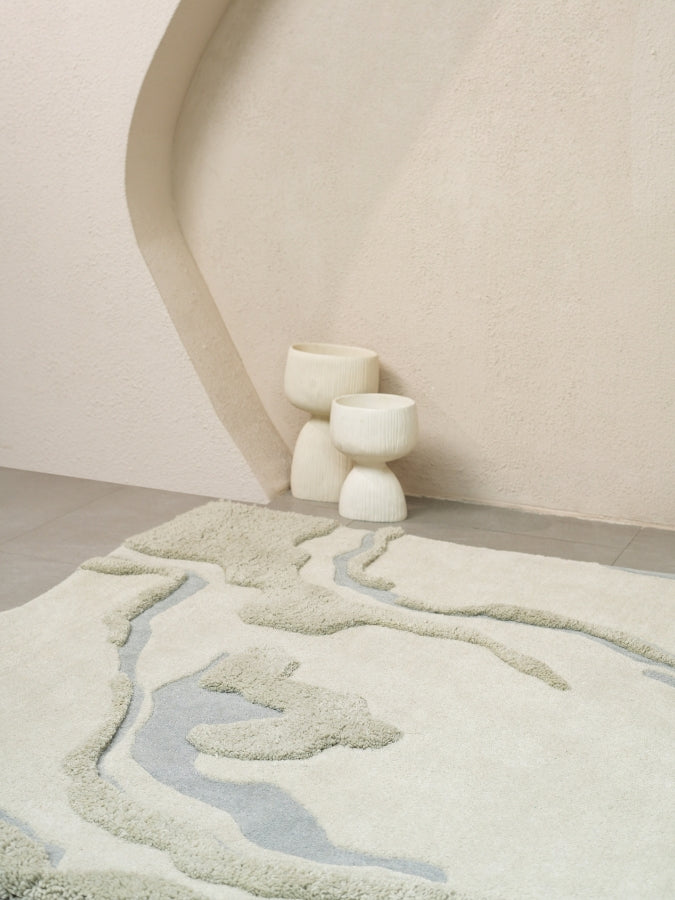 Dust Lake textured rug with soft grey tones and muted blue accents, inspired by calm waters.