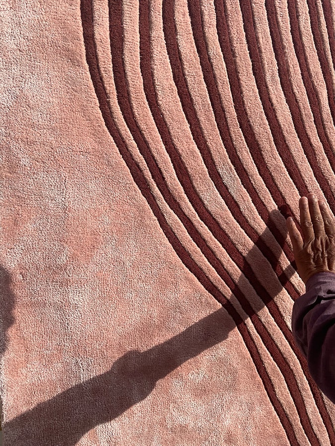 Dunes Rug displaying its unique embossing, capturing the essence of wind-swept sand dunes with a soft, inviting texture.