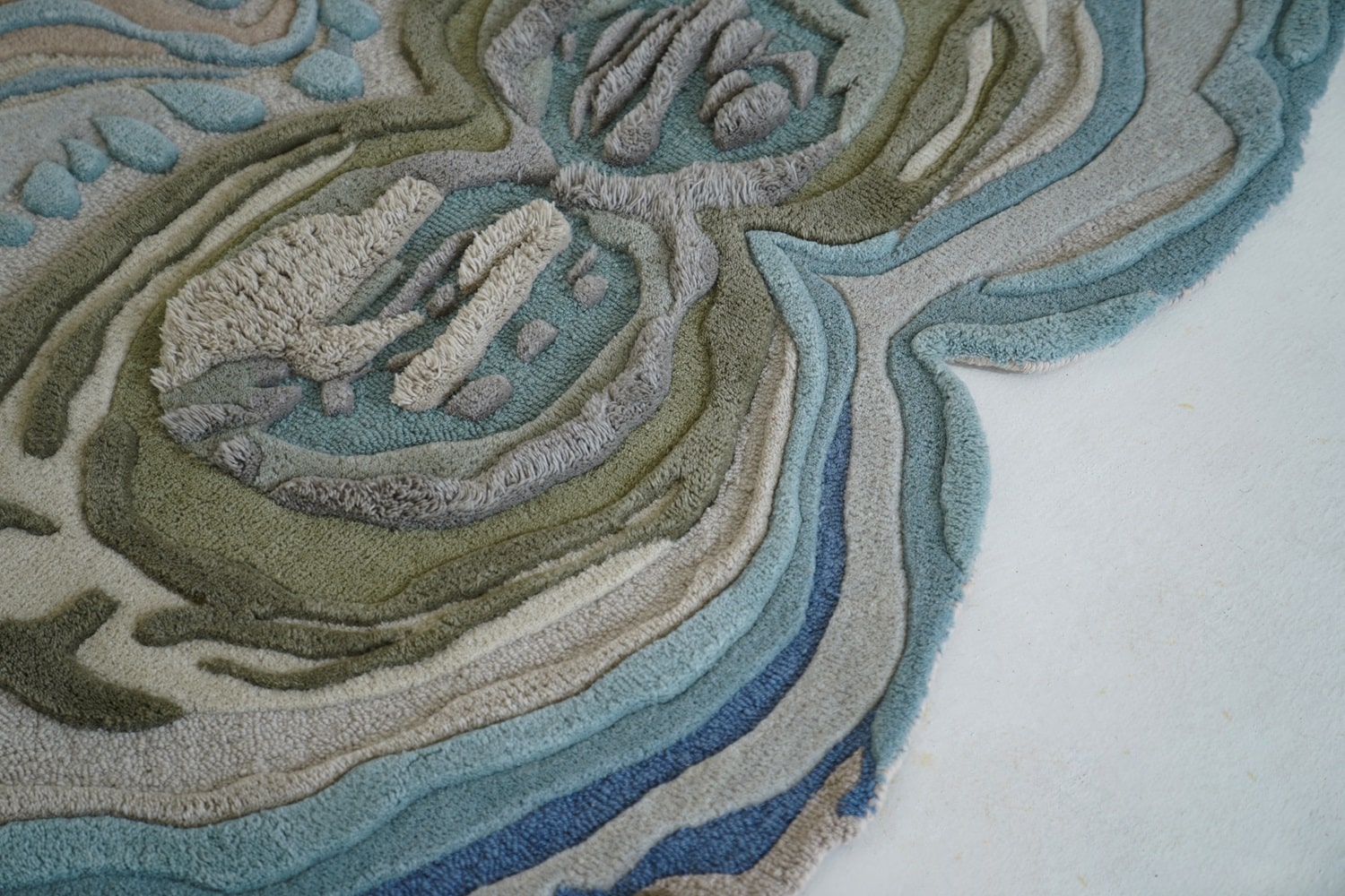 Close-up of the Geostone Rug, highlighting the soft texture and intricate high-low piles that enhance its tactile and visual appeal.