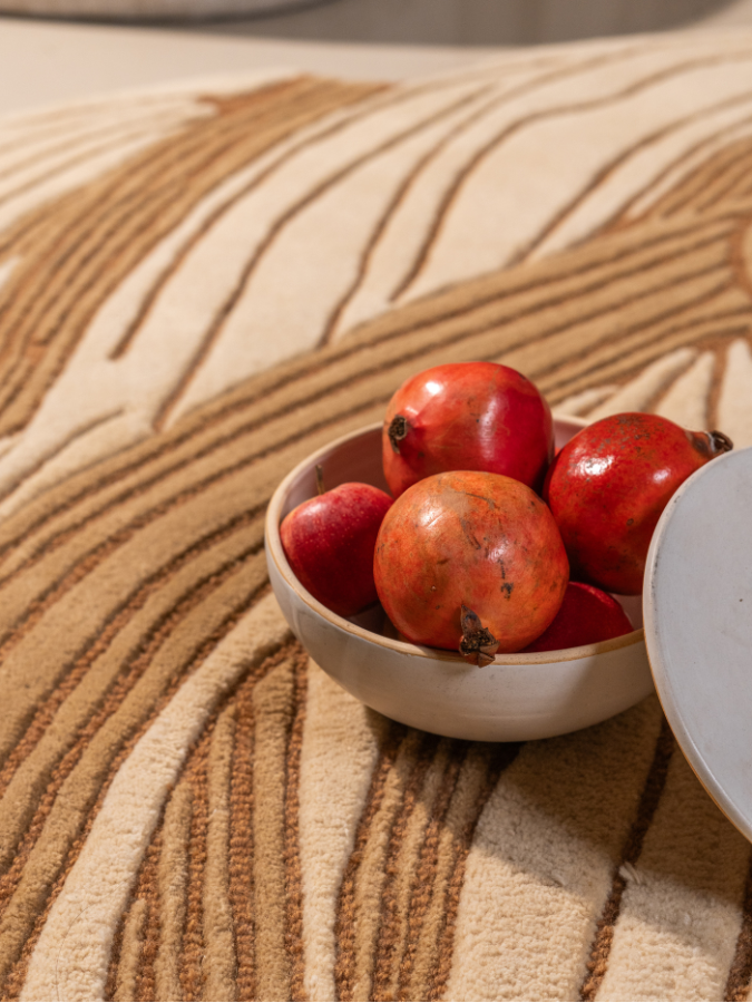 Sculptural wool rug with raised textures and fluid, nature-inspired design.