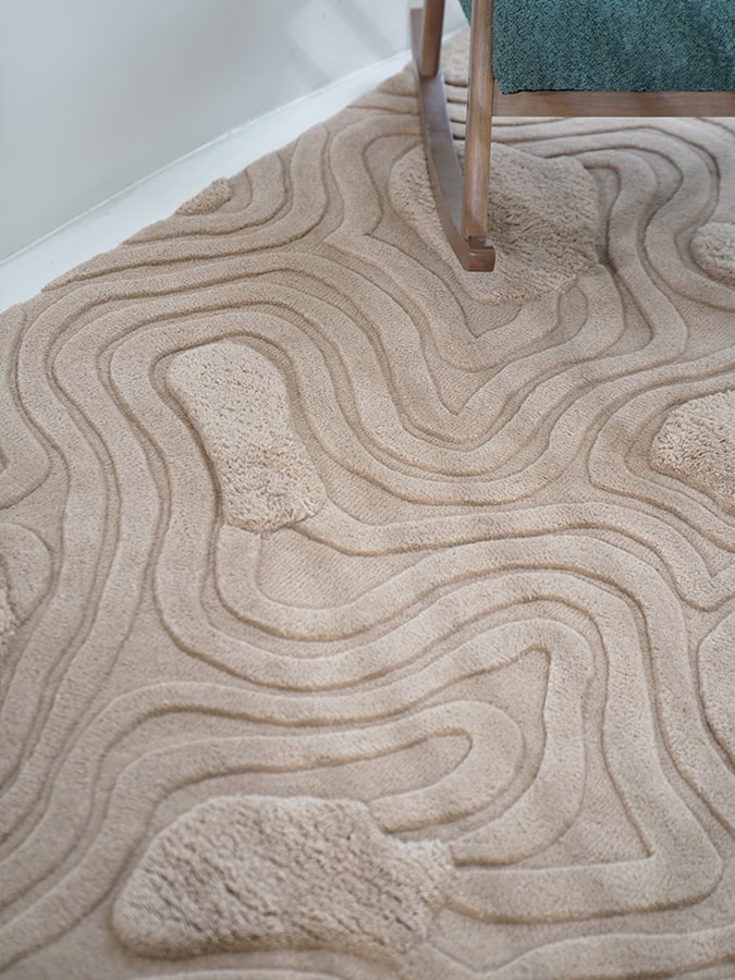Close-up of the Highlands Rug showing the dynamic interplay of high and low piles that mimic the undulating terrain of hills.