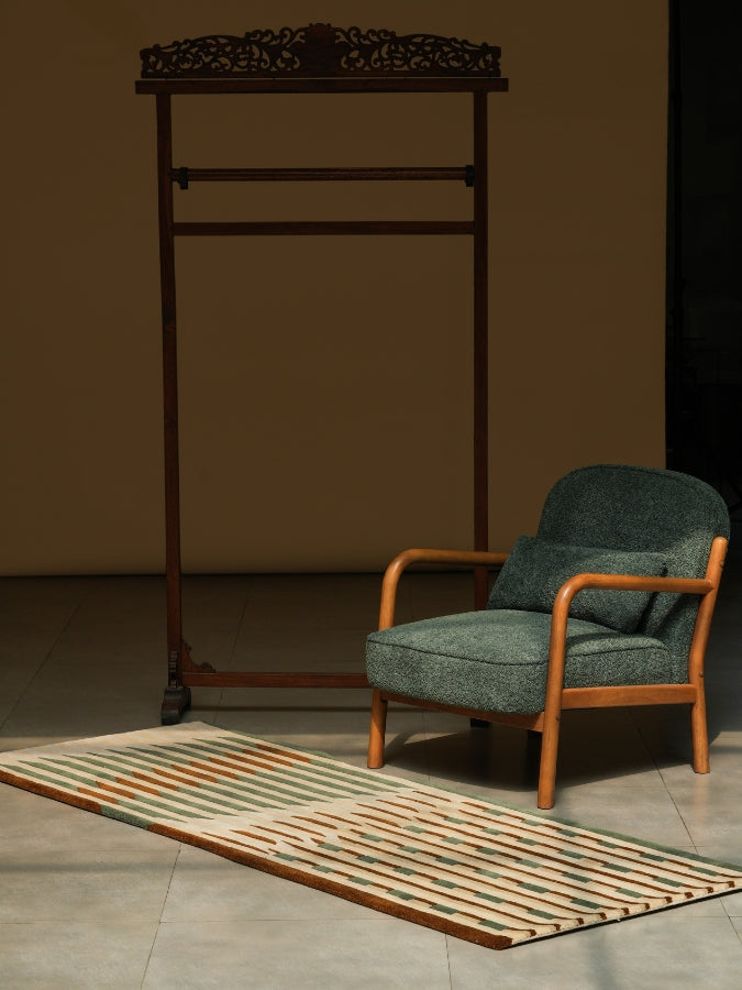Line of Thought textured rug with earthy greens, browns, and ivory stripes in a modern geometric pattern.