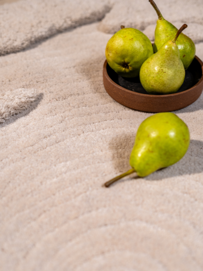 Close-up of Moon Pond rug showing soft wool textures and sculpted ripple patterns.
