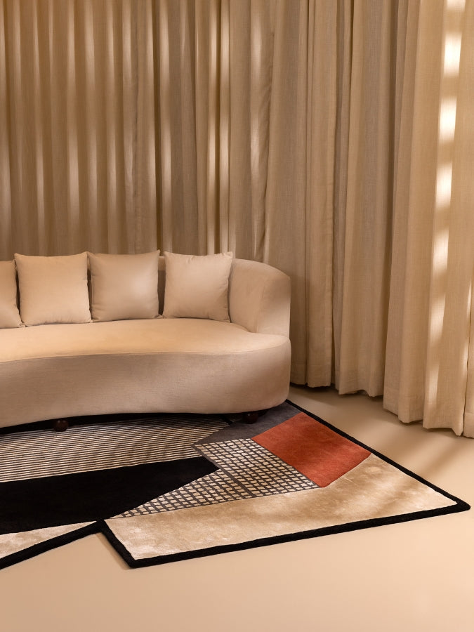 Mosaic Groove Tangerine textured rug with geometric patterns in tangerine, black, and ivory tones.