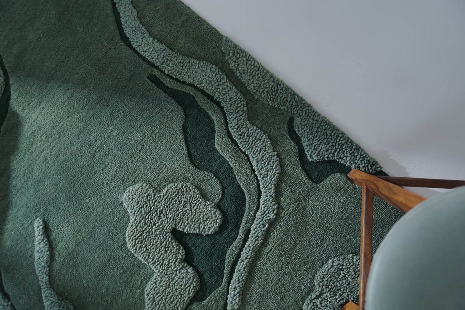 Close-up of the Moss Mounds Rug's texture, showing the detailed craftsmanship and earthy green hues that replicate the soft undulation of moss