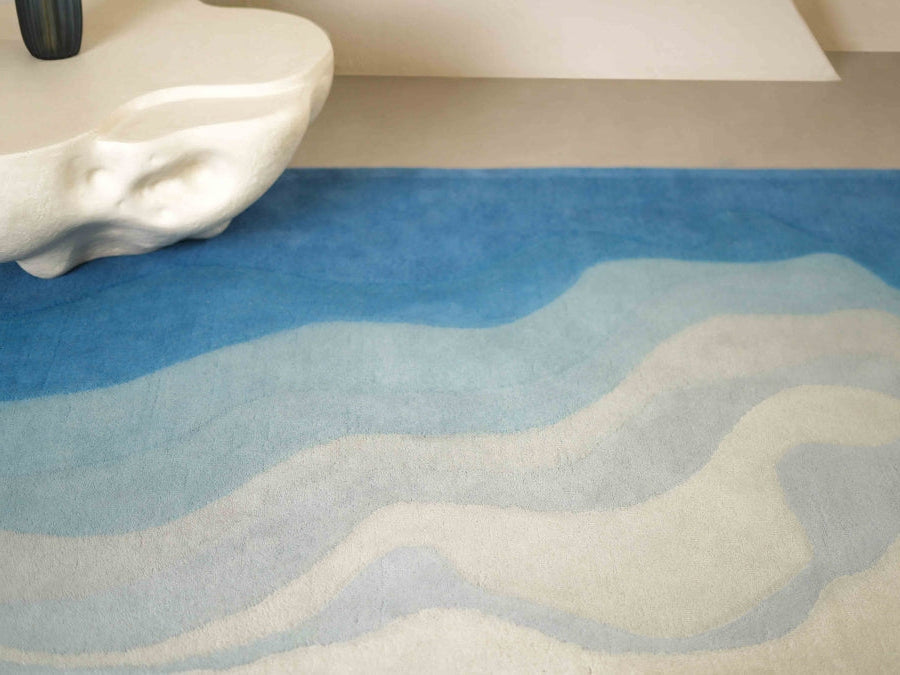 Facing the Sea hand-tufted rug with layered ocean blue tones.