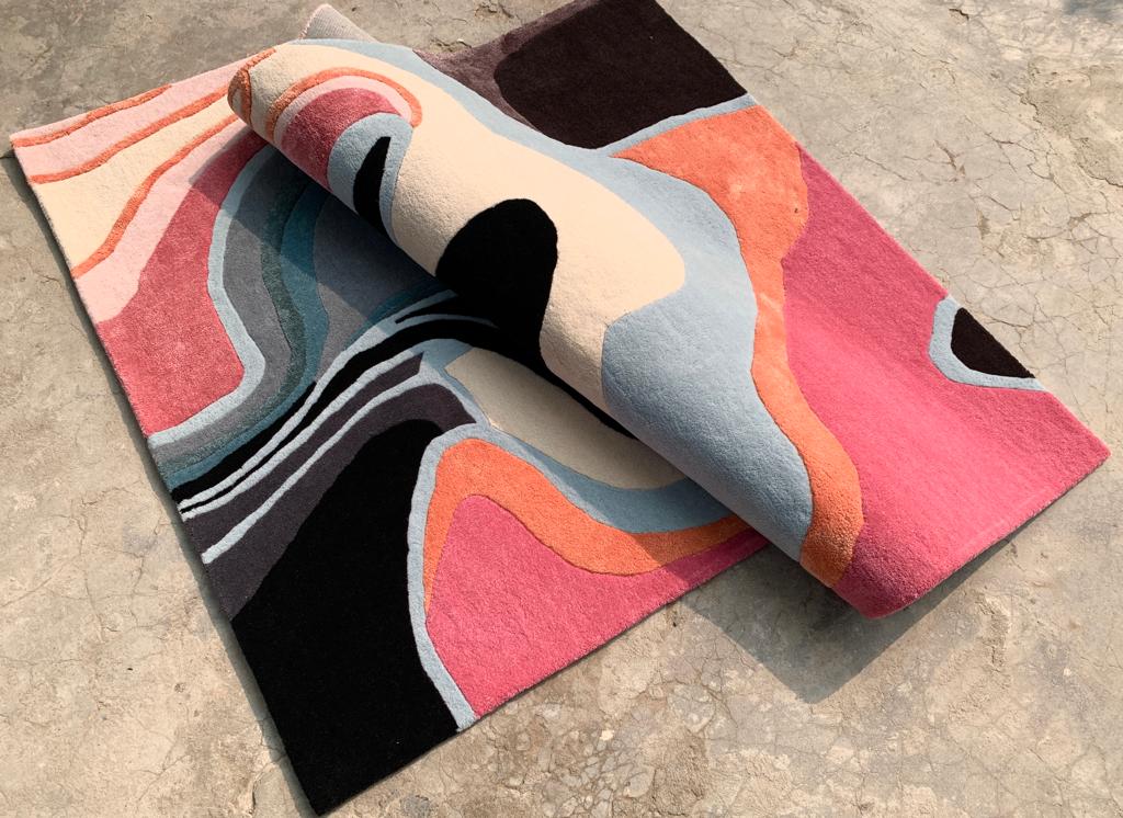 Pathos Rug showcasing its rendition of emotional waves through bright hues and detailed patterns, adding beauty to home decor.