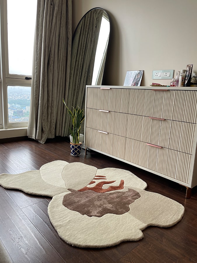 Rafflesia Rug in a chic room setting, illustrating its ability to add a soft, delicate impression with its unique floral pattern.
