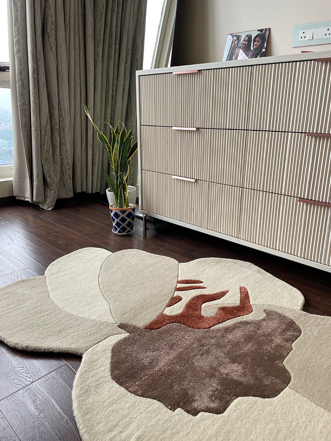 Angle view of the Rafflesia Rug on the floor, showcasing its elegance and the eccentric charm it brings to any space.