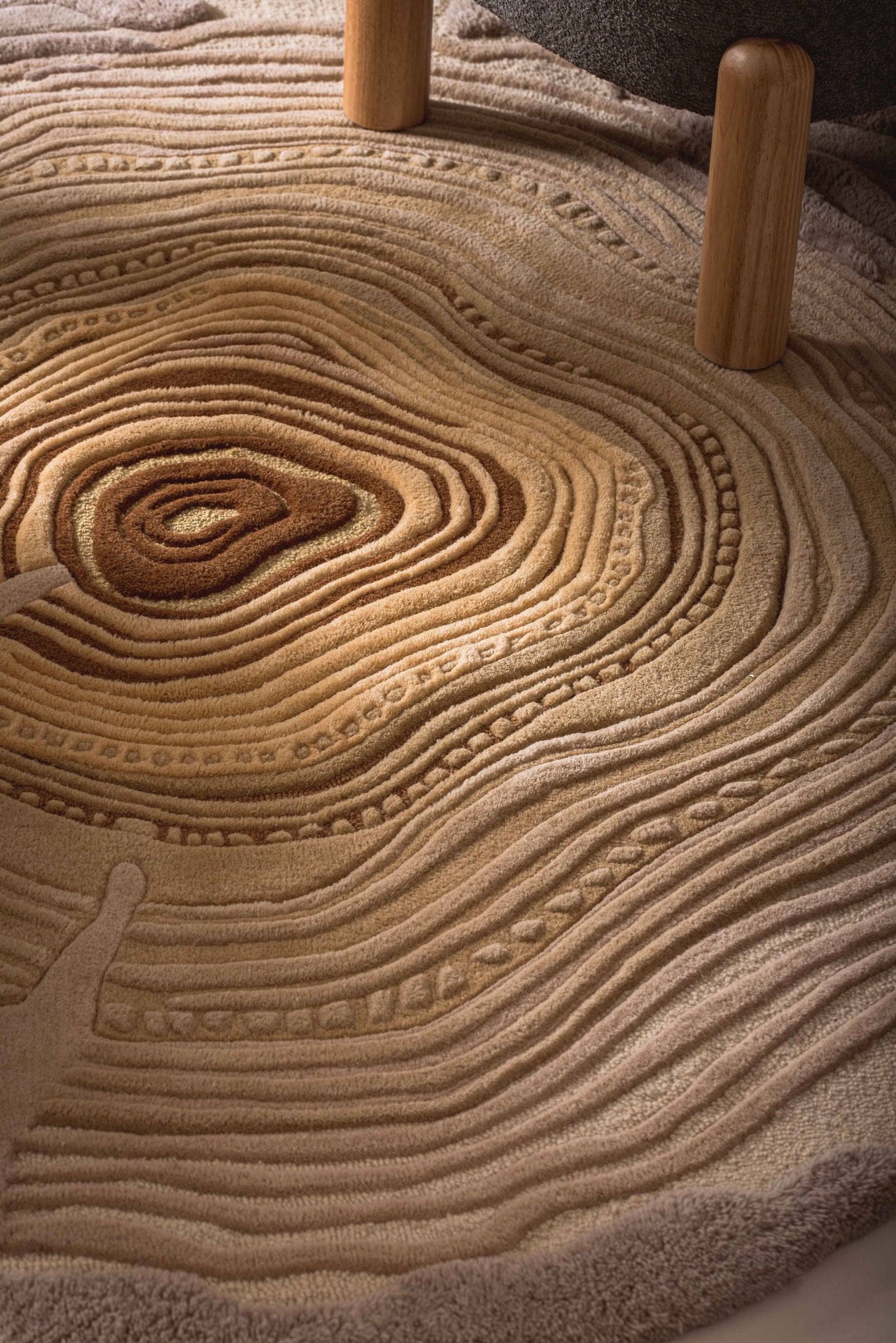 Close-up of the Rings of Wisdom textured rug, showcasing its intricate hand-tufted design and natural tree-inspired details.