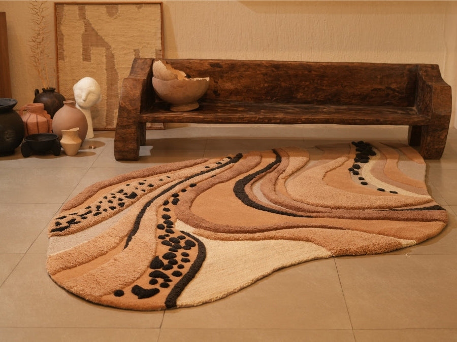 Sandstorm textured rug featuring soft beige, tan, and charcoal swirls inspired by desert dunes.