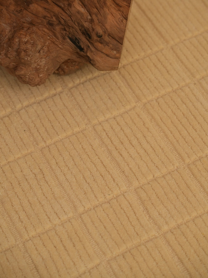 Neutral ivory textured rug styled in a contemporary interior space.
