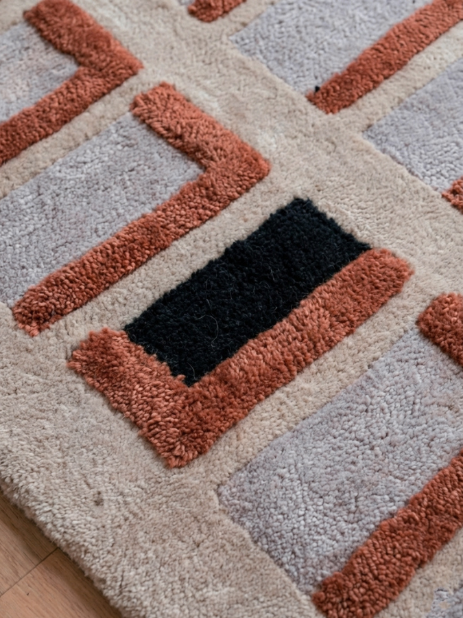 Close-up of Spatial Memory rug showing hand-tufted wool texture and layered high-low pile.