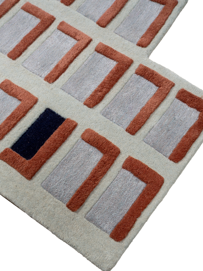 Spatial Memory rug styled in a modern interior, adding architectural rhythm and contrast to the space.