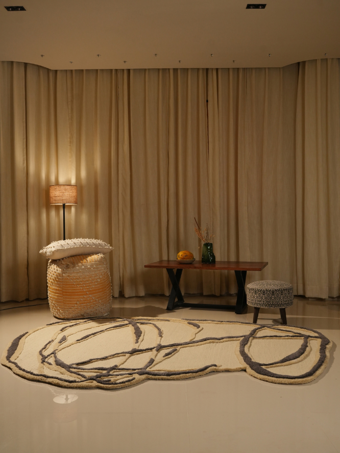 contemporary art-inspired wool rug with raised textures and freeform patterns in a living room setting.