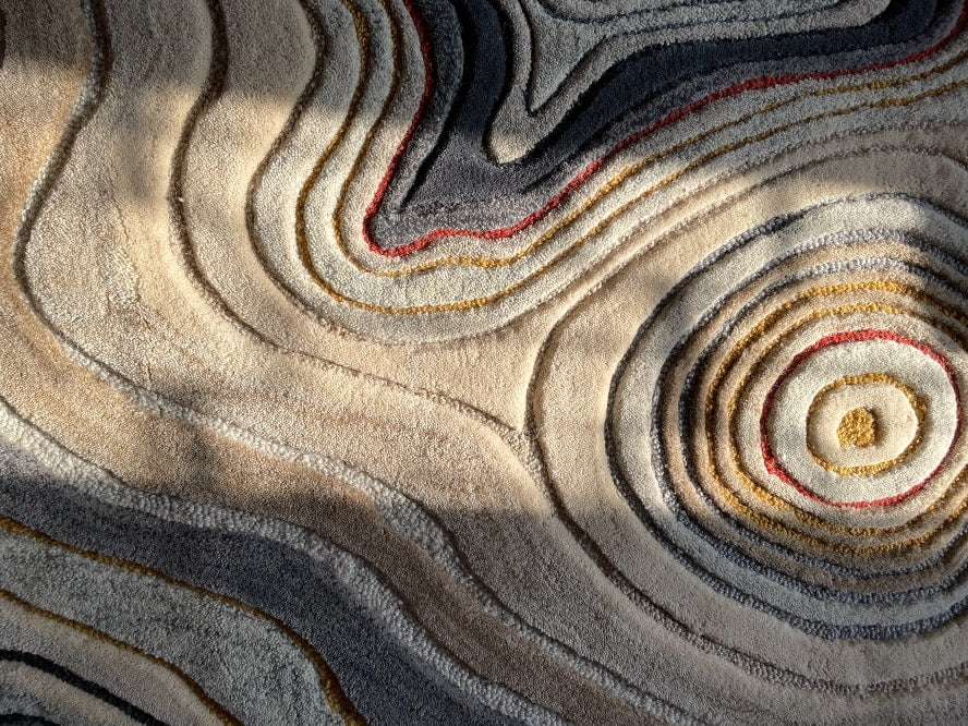 Close-up of the Uncanny Valley Rug, highlighting the high-low pile design that mimics the natural flow across loose sand.