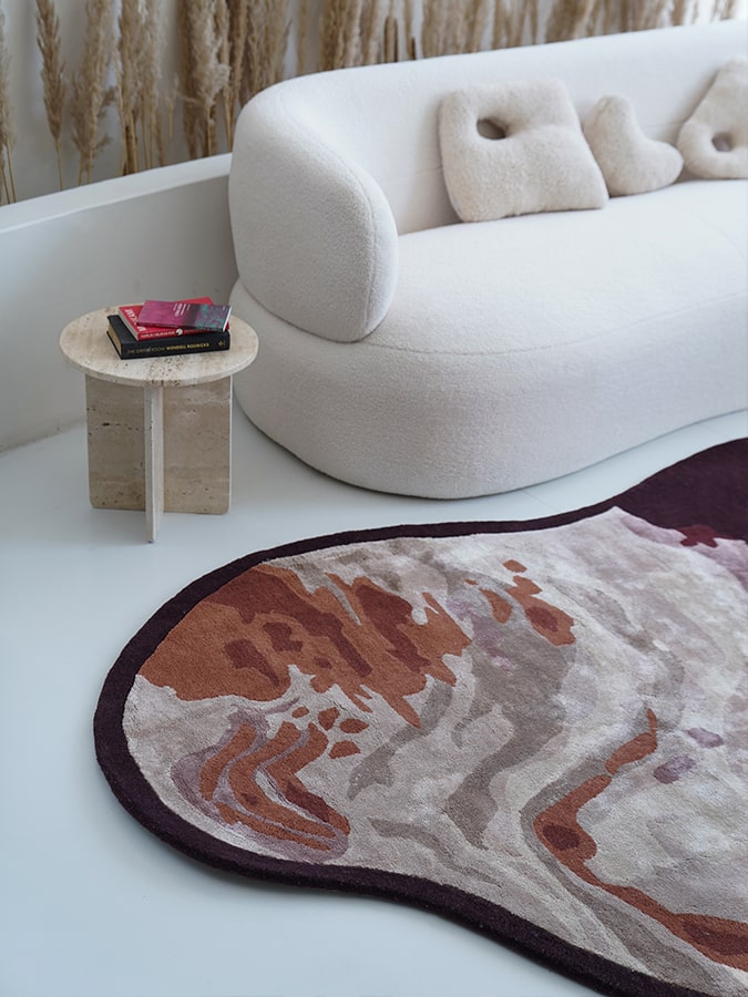 Close-up of the Wine Whisper Rug's abstract shape and intricate hand-tufted details, highlighting the luxurious blend of New Zealand wool and viscose.