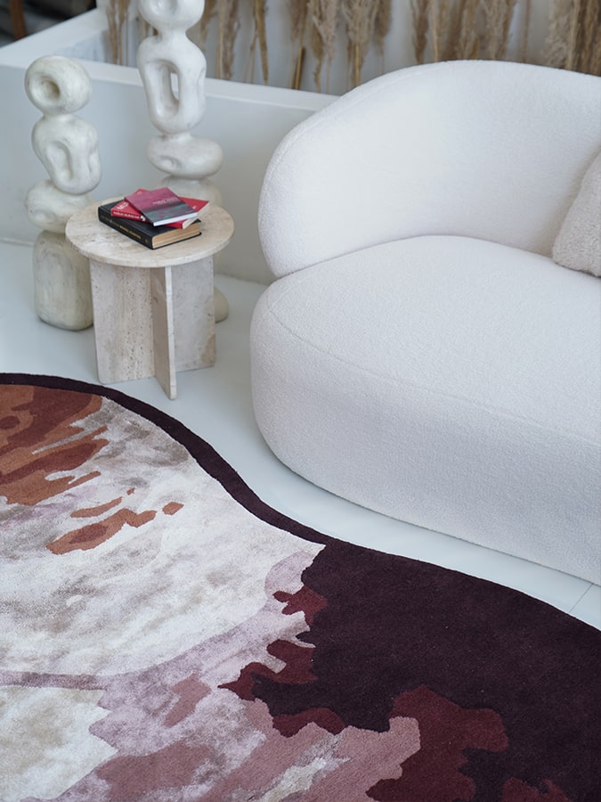 Wine Whisper Rug displayed in a well-lit room, showcasing its swirling patterns and rich burgundy hues.