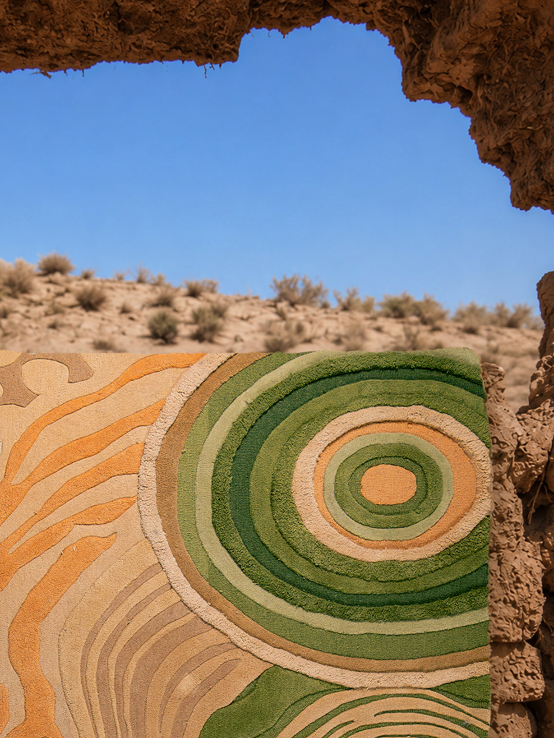 Close-up of Feral Ground rug highlighting layered hand-tufted textures, sculpted pile heights, and organic earthy color variations.