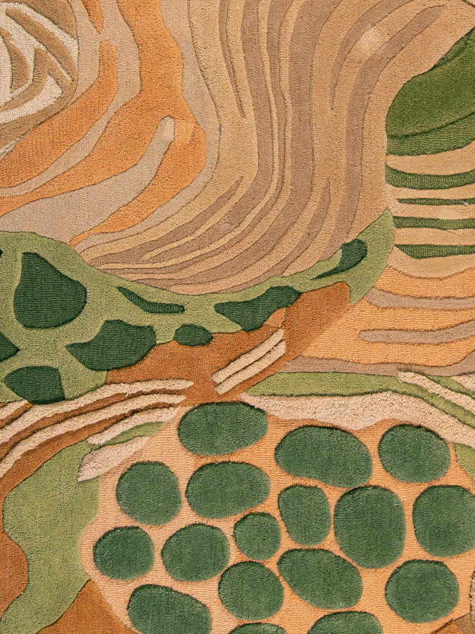 Close-up of Feral Ground rug highlighting layered hand-tufted textures, sculpted pile heights, and organic earthy color variations.