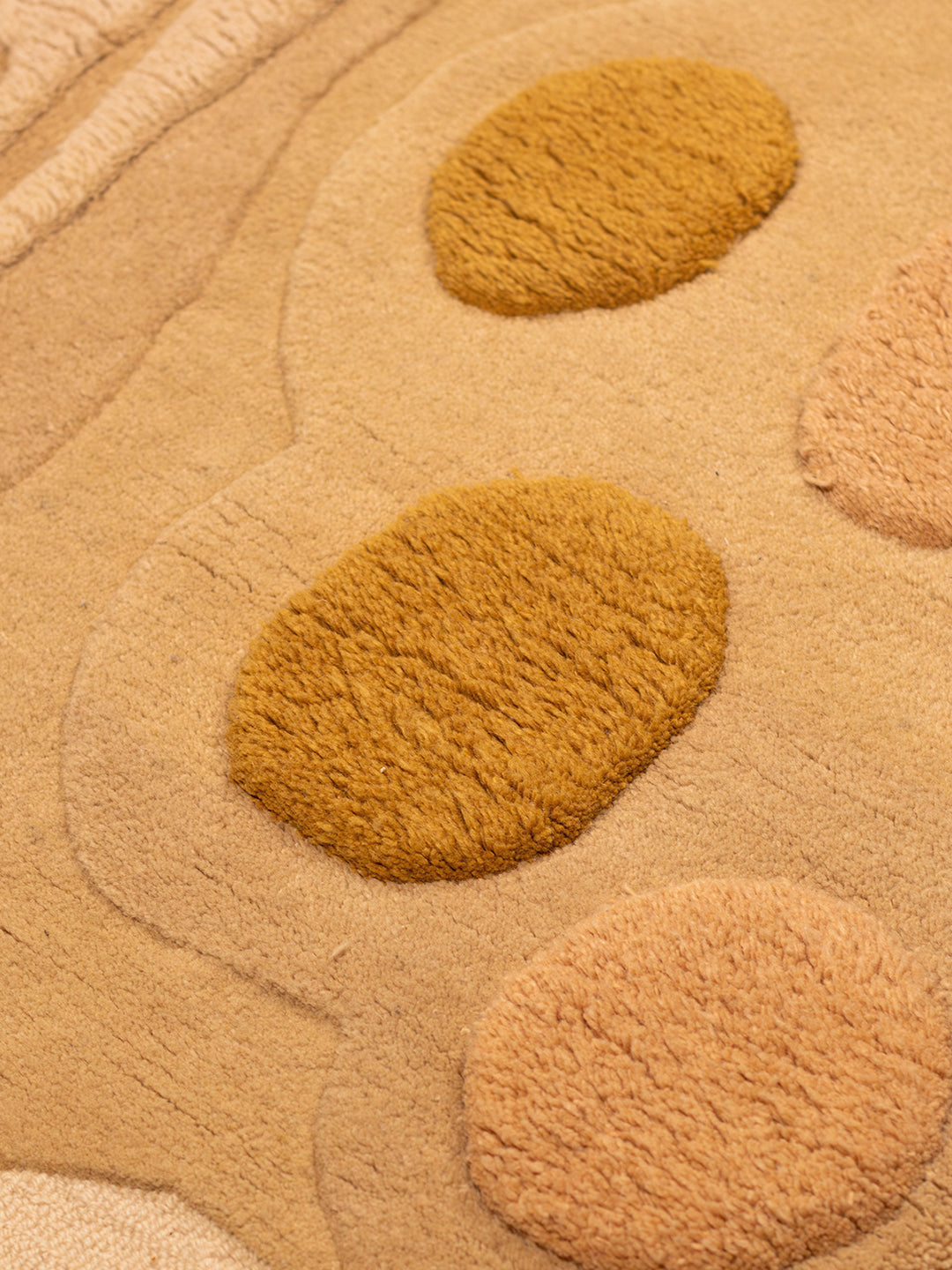 Desert Bloom hand-tufted rug in ochre, taupe, sage green, and brown, inspired by desert landscapes and crafted from 100% New Zealand wool.