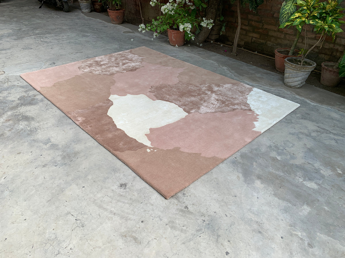 Salmon hand tufted rug in coral and soft tonal hues, a regal accent for a living room or bedroom.