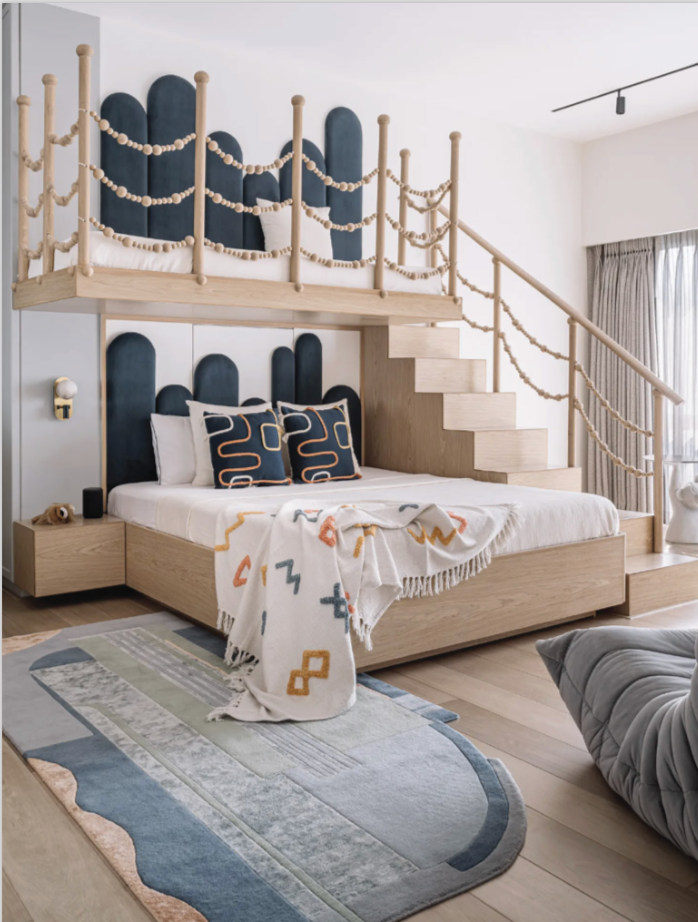 Skyline hand-knotted wool and viscose rug with blue and grey geometric sections beside a wooden bed